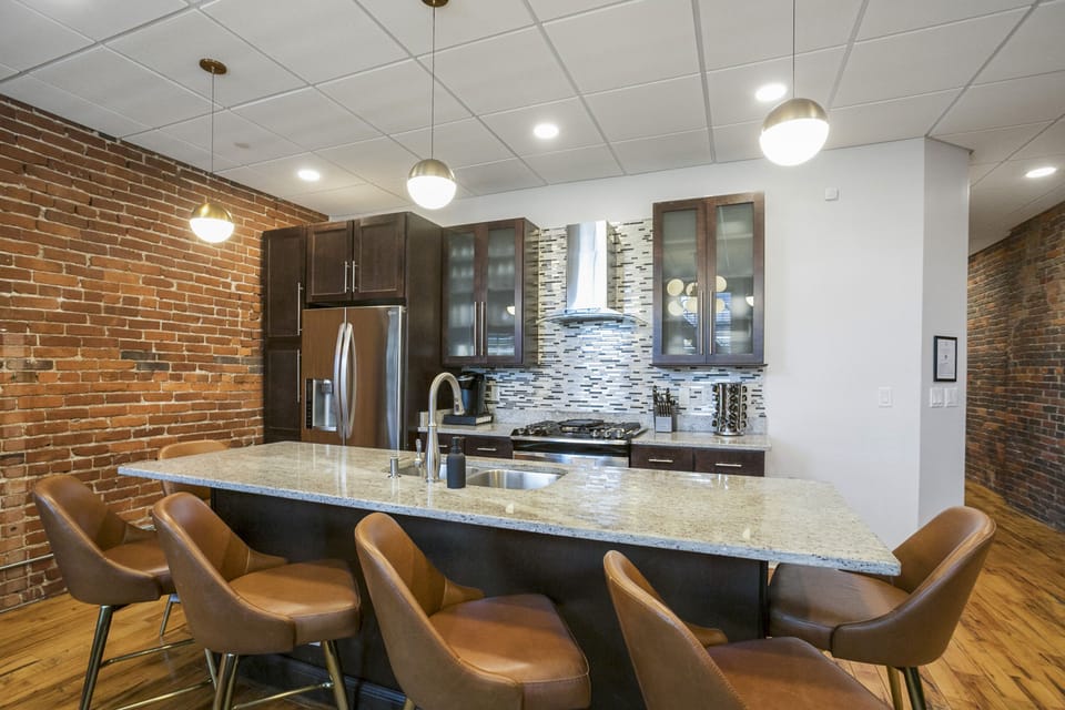 - Modern kitchen with granite island seating perfect for hosting and dining - Stainless steel appliances and sleek cabinets add comfort to your Nashville stay - Open layout makes cooking and gathering easy for groups and families