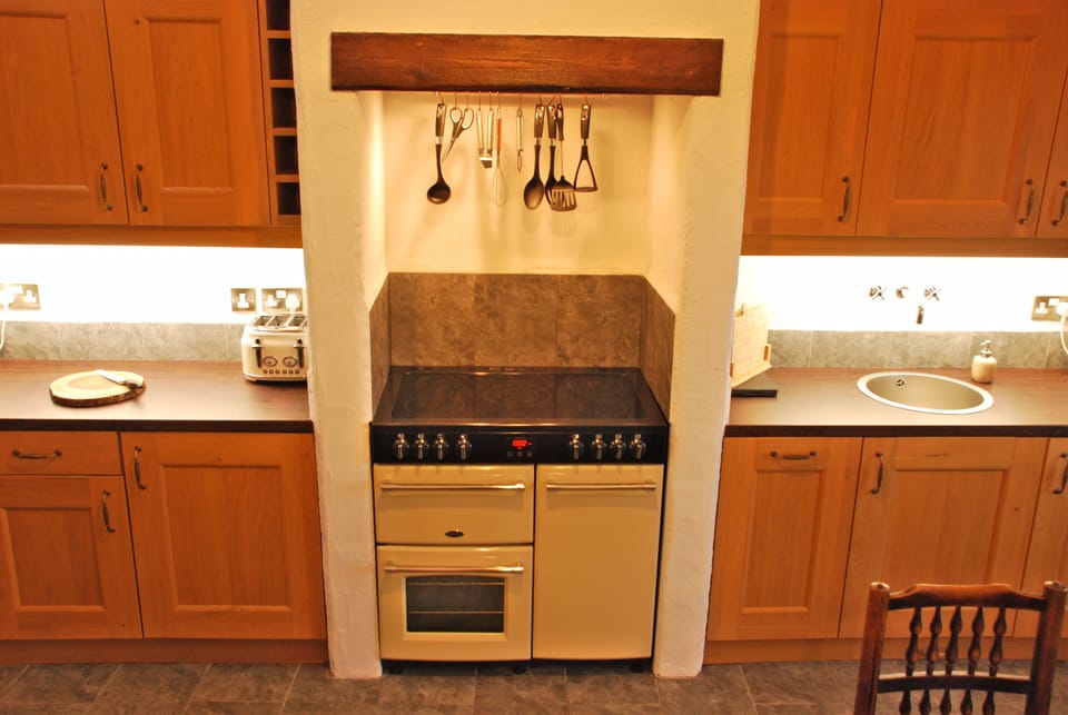 Farmhouse range cooker set in chimney recess