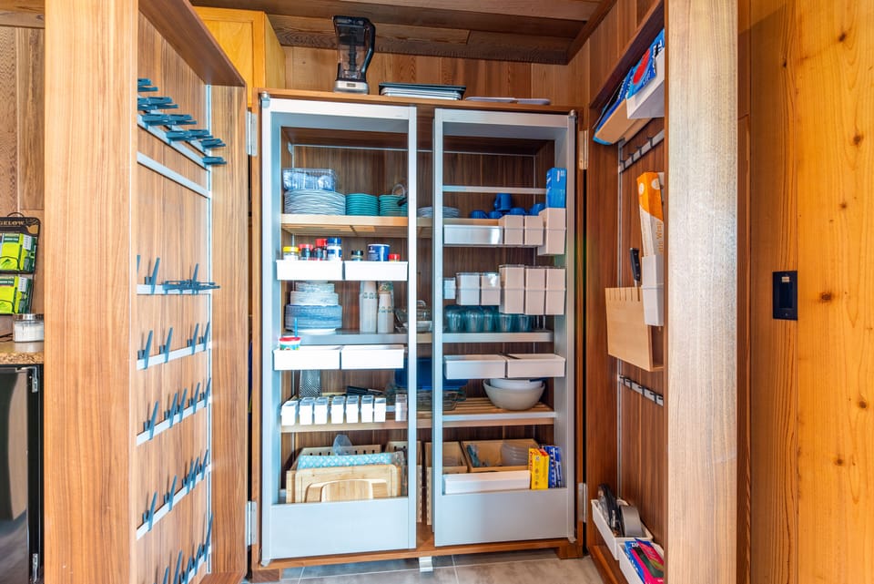 Kitchen is fully-stocked with utensils, condiments, and more.