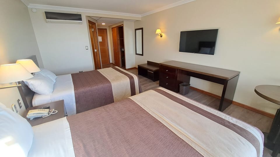 Double Room, City View | Minibar, in-room safe, desk, blackout drapes