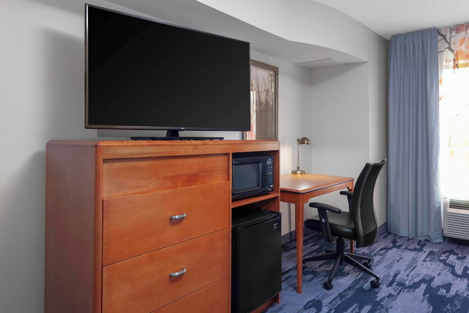 Desk, laptop workspace, blackout drapes, iron/ironing board