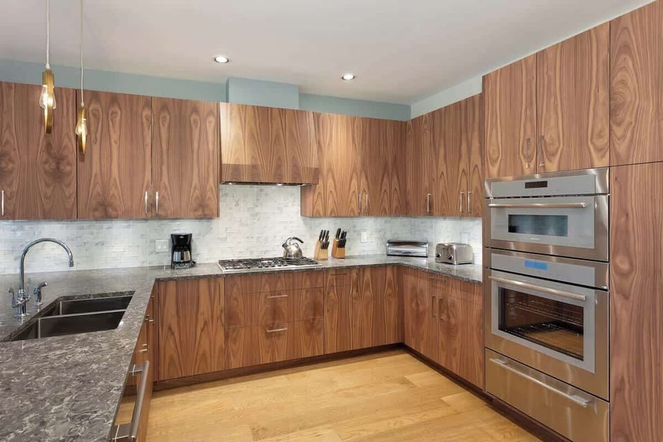 - Sleek kitchen with rich walnut cabinetry and stainless-steel double ovens  
- Expansive counters and modern lighting perfect for cooking or entertaining  
- Equipped with premium appliances and all essentials for a chef-style stay 