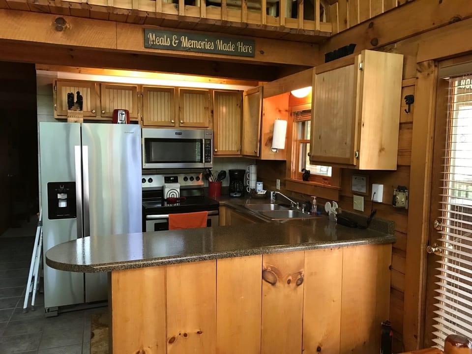 Fully equipped kitchen including a blender, crock pot and waffle maker.