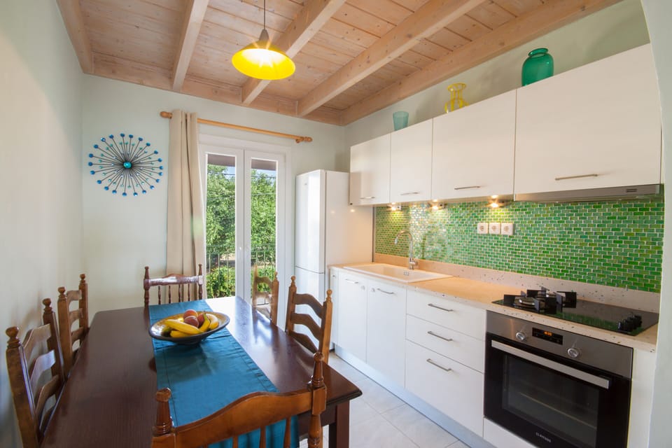 Fully equipt kitchen and dining area. Doors open onto the street facing balcony