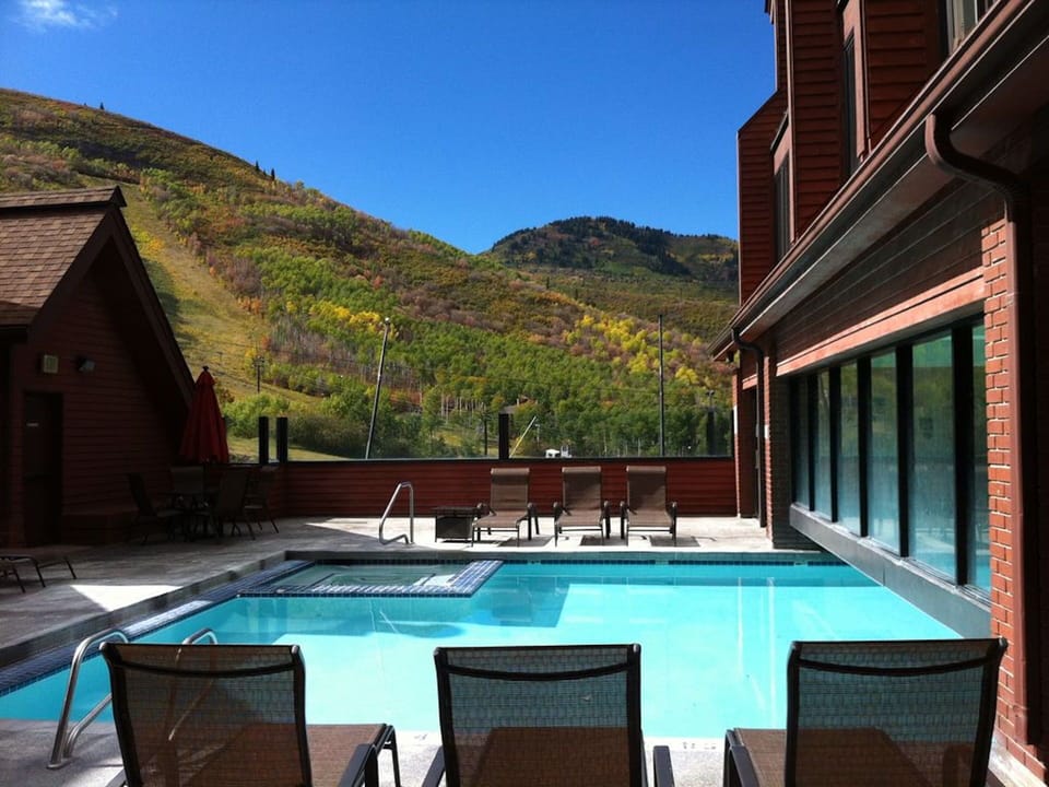 Oudoor/indoor swimming pool with hot tubs outside (in far corner) and inside