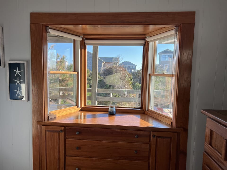 Blue Fish room -- queen bed with bay window overlooking back deck 