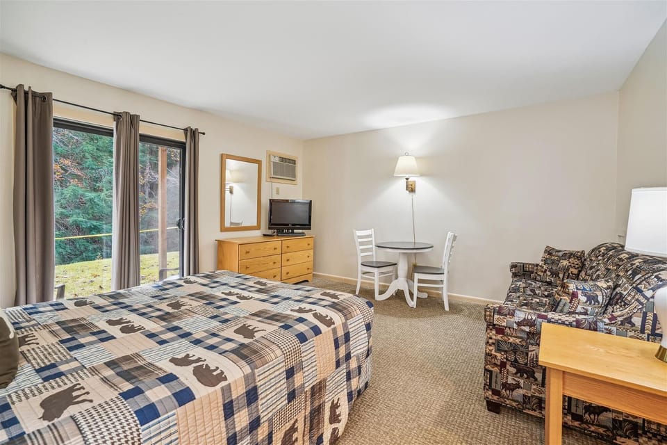 Relax in the living area with a pull out sofa, dinette, TV, and sliding glass doors leading to the padio.