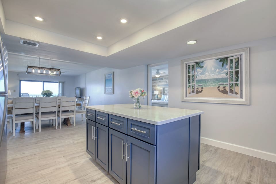 Open-concept kitchen with a sleek island, recessed lighting, and modern decor.