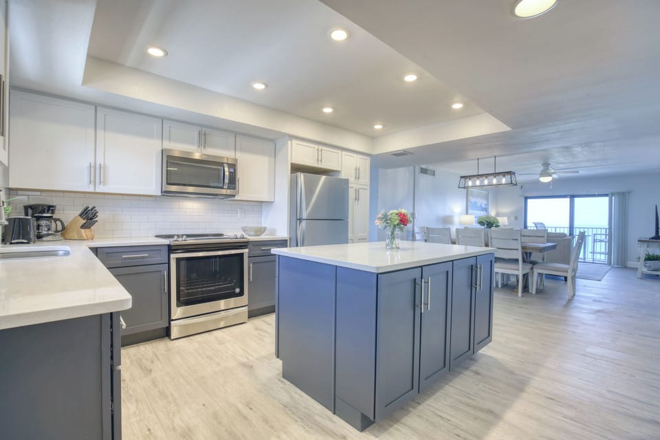 Spacious kitchen with sleek cabinetry, stainless steel appliances, and a large island.