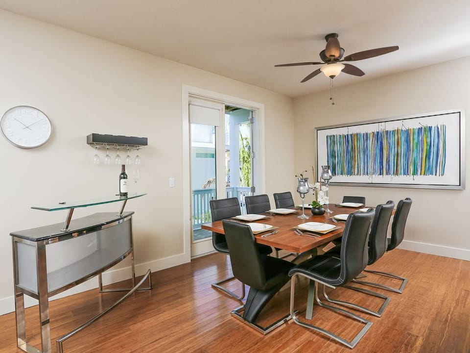 Dining table has seating for 8 and sits just outside the balcony french doors