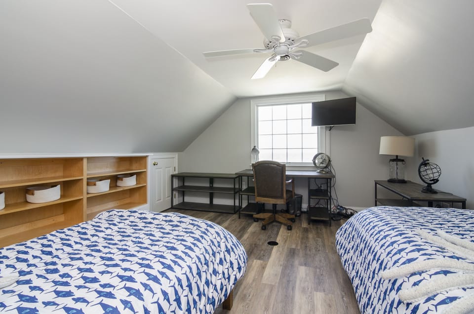 3rd floor room with two twin beds, TV, and ocean view