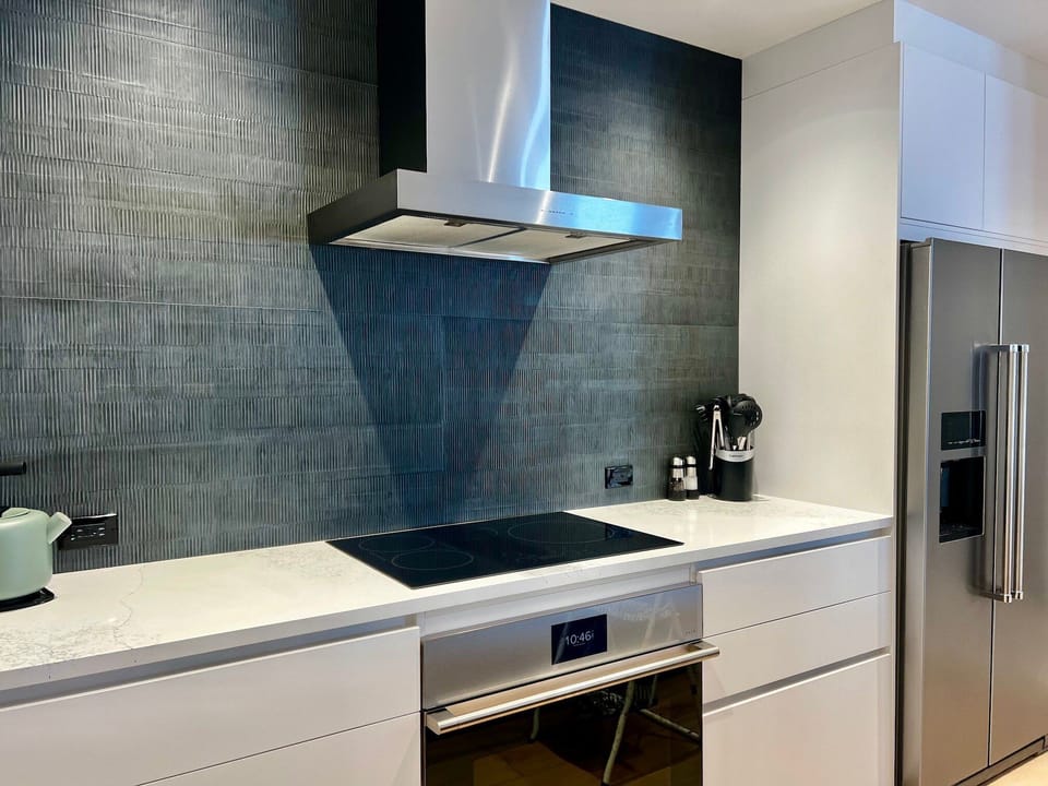 Updated modern kitchen with all stainless steel appliances.