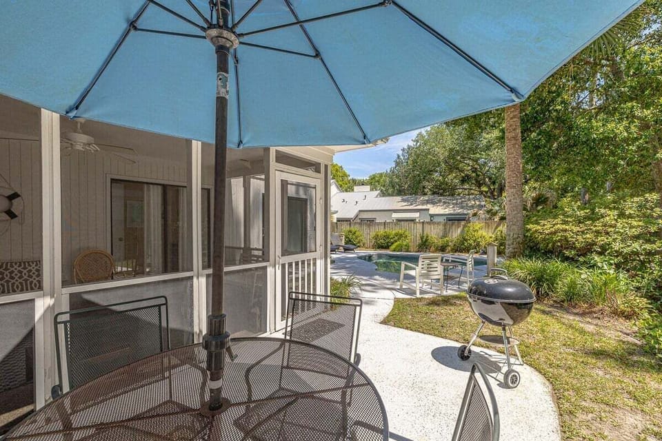 Pool area with lounge chairs and umbrellas