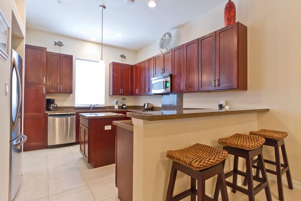 Our kitchen boasts full size appliances, center island, and breakfast bar for 3.