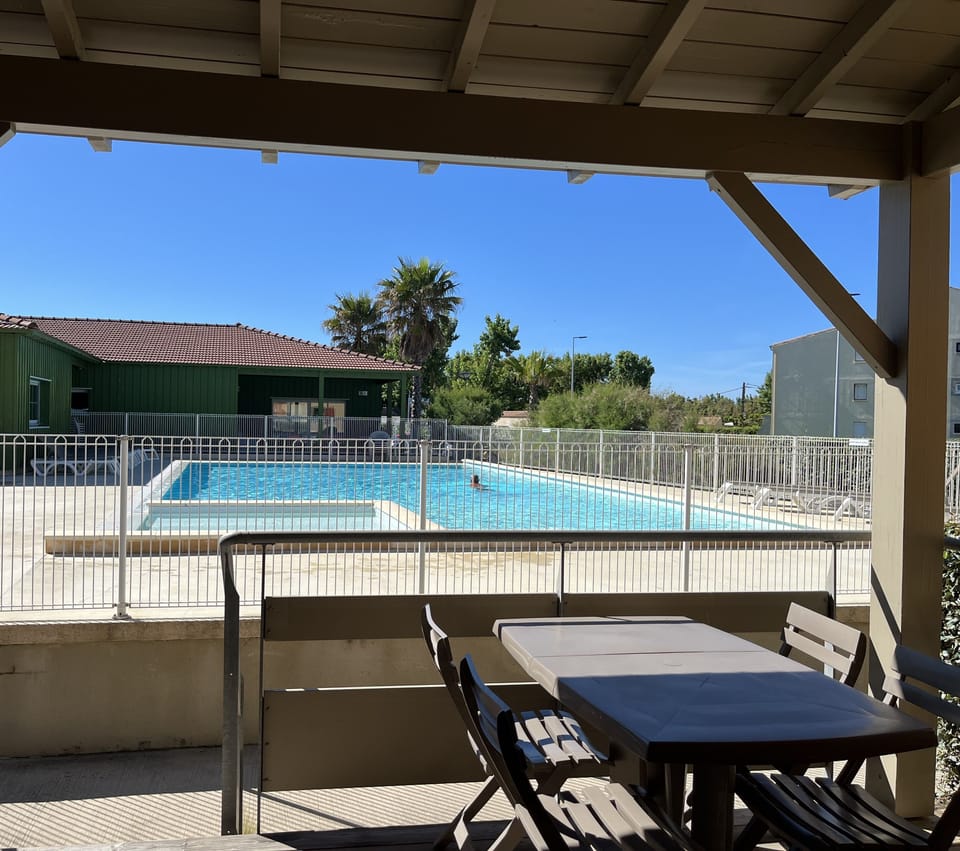 Open from April to October, the shared pool sits under a covered patio just steps from your unit.