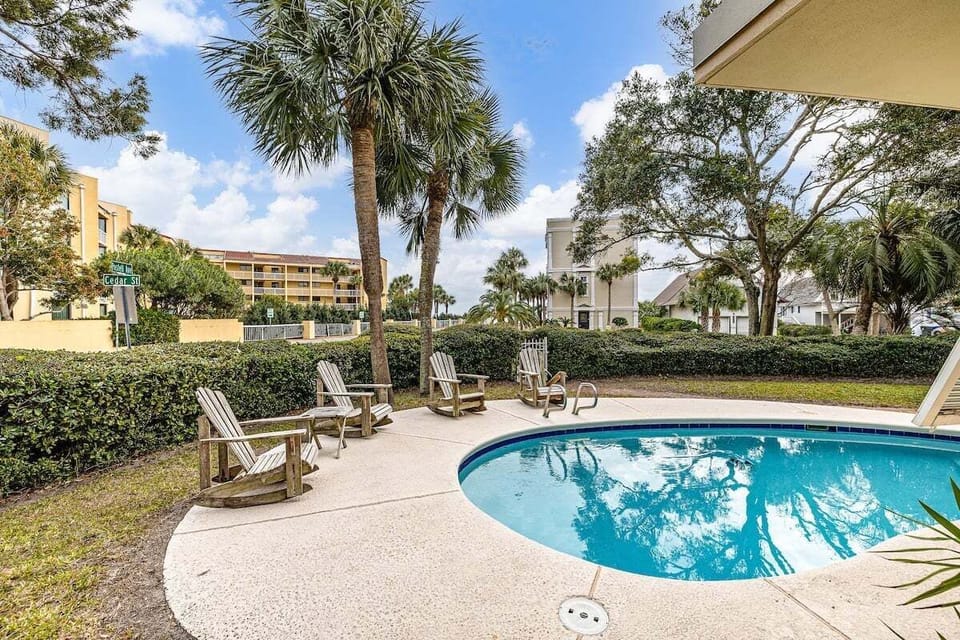 Pool area with surrounding lounge chairs