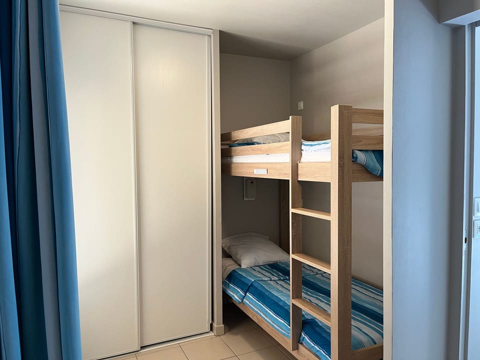 The kids' alcove fits a set of bunk beds — they'll be asleep fast after a day at the pool and beach.