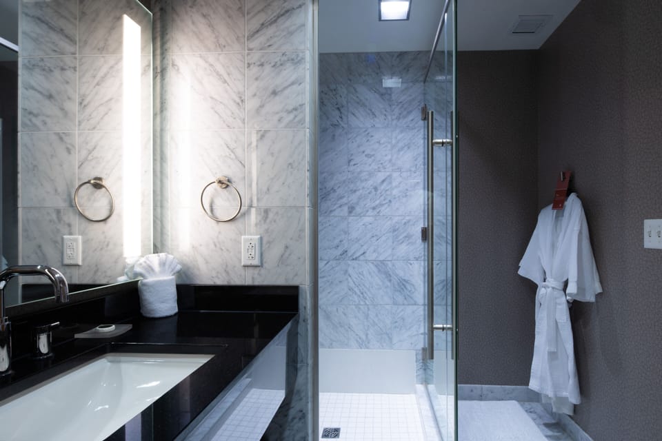 Shower, designer toiletries, hair dryer, bathrobes