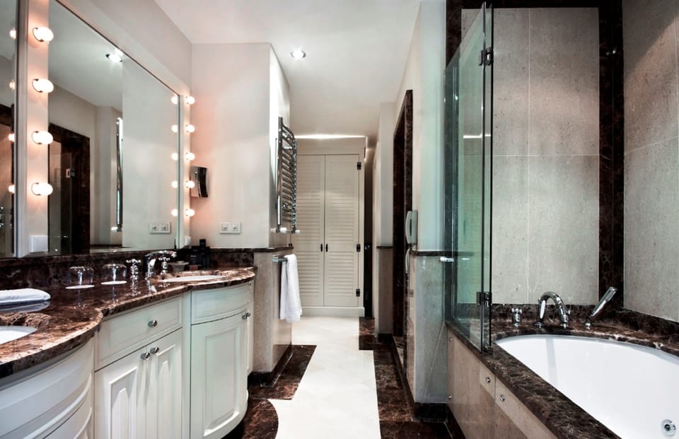 Separate tub and shower, designer toiletries, hair dryer, bathrobes