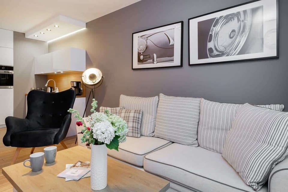 Another view of the living room showcasing stylish furniture, framed art, and decorative touches, enhancing the modern feel of the space.