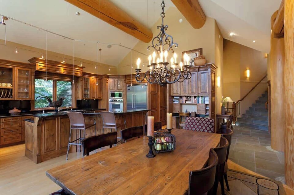 - Rustic dining and kitchen flow together in a cozy, open mountain-lodge setting  
- Beautiful wooden table under chandelier lighting for memorable shared meals  
- Ideal for families and groups seeking connection, comfort, and alpine ambiance  