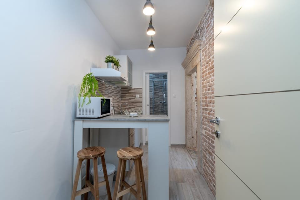 Fridge, electric kettle, cookware/dishes/utensils, paper towels