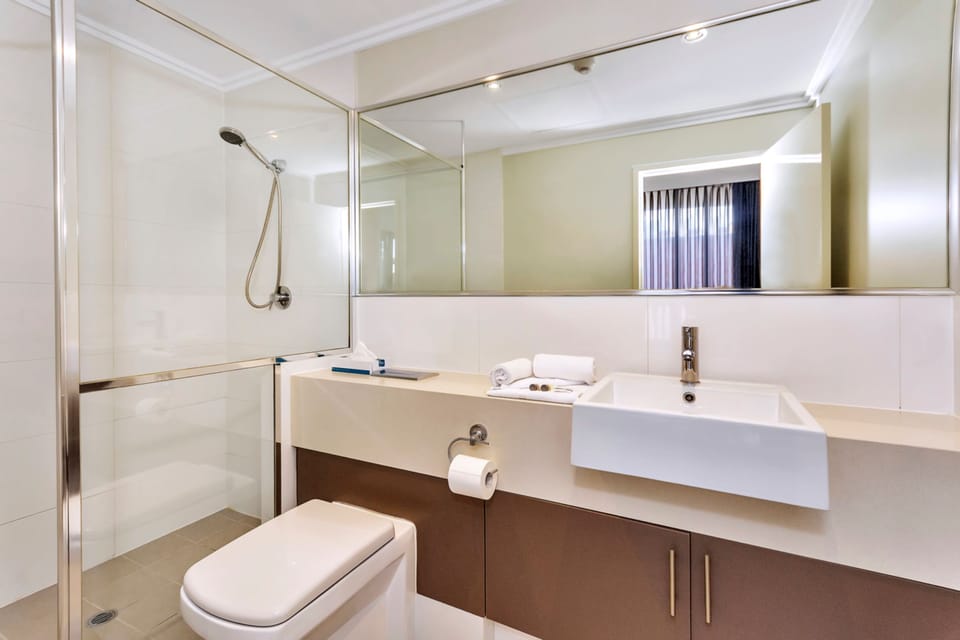 Shower, designer toiletries, hair dryer, towels