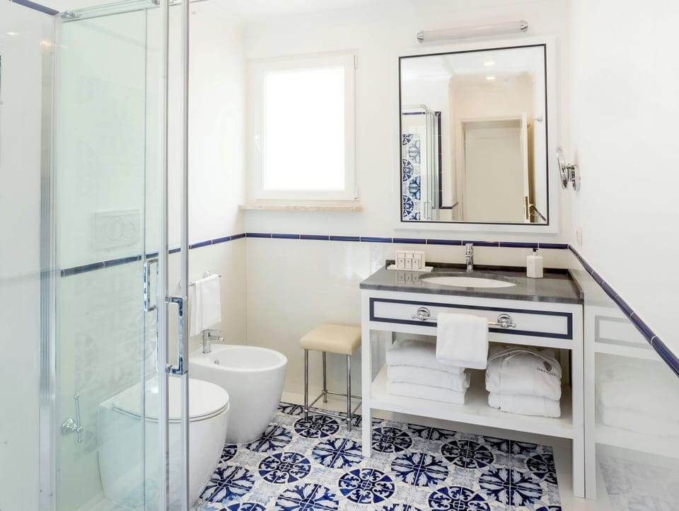 Signature Suite, 1 King Bed, Balcony, Sea View | Bathroom | Hair dryer, bathrobes, slippers, bidet