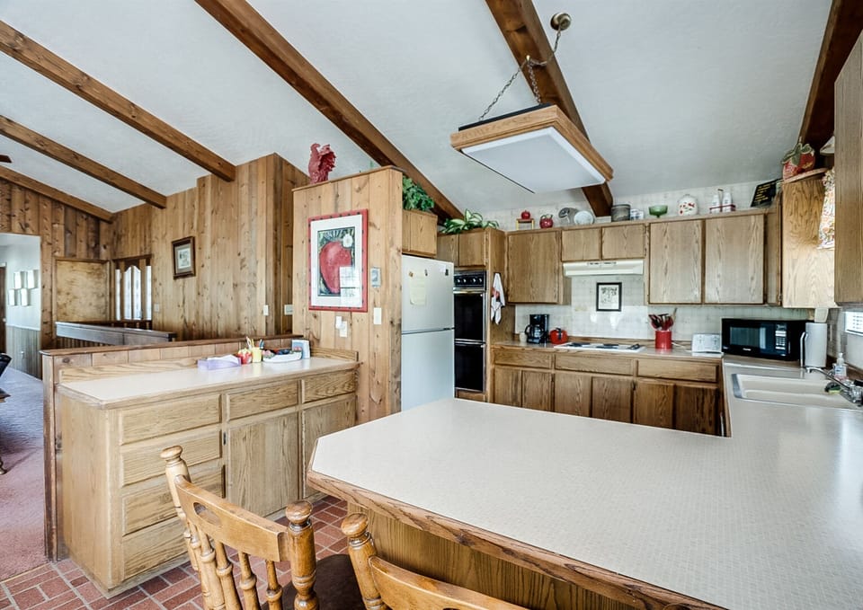 Cook, connect, and savor comfort in this sunlit, rustic kitchen retreat.