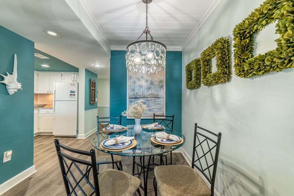 Seating for 4 at the dining room table with additional seating at the bar.