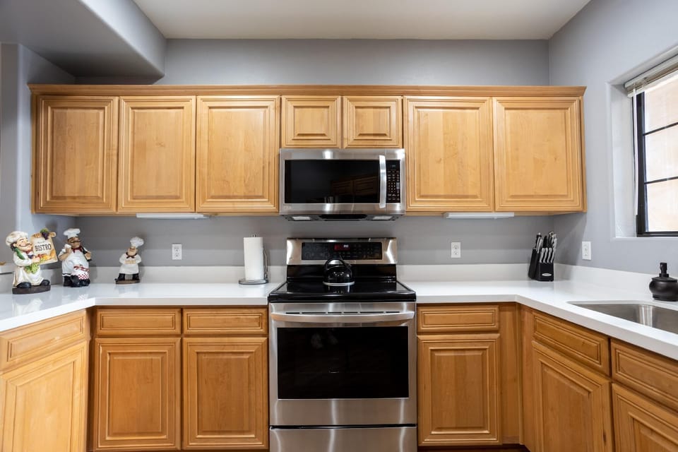 Fully stocked kitchen with modern appliances.