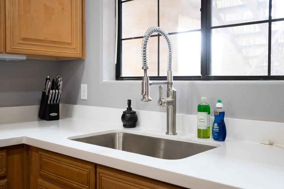 Large sink with perfect lighting in the kitchen.
