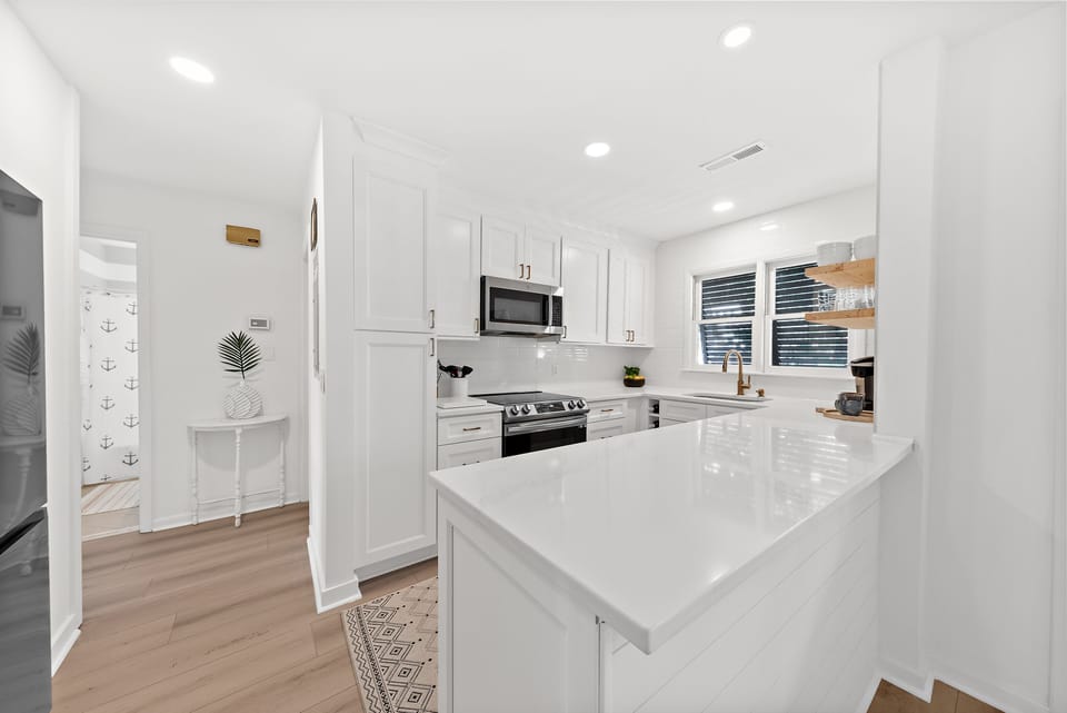 The kitchen has custom cabinets and stainless steel appliances.