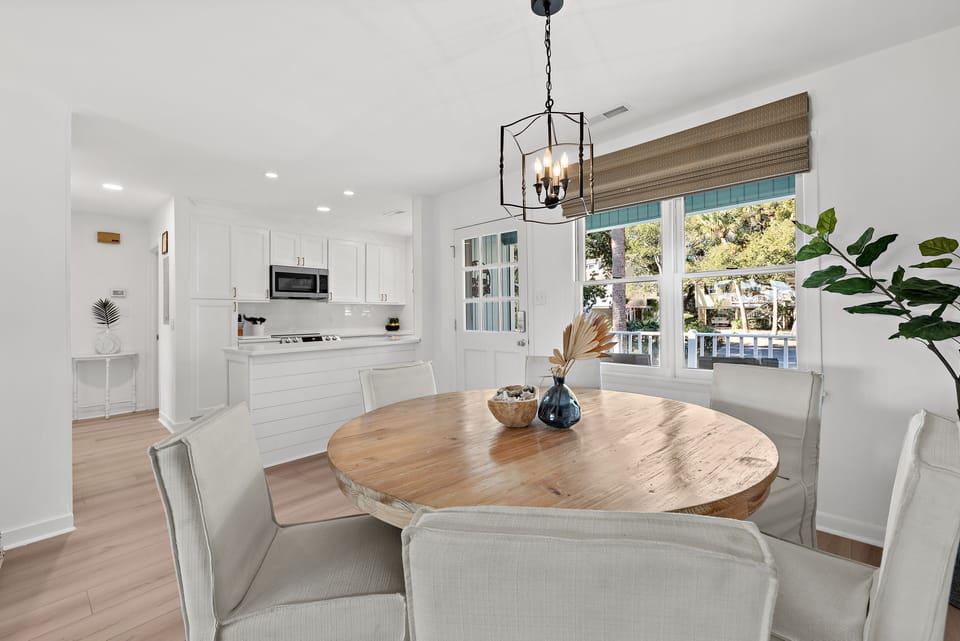 The dining table seats six and is open to the kitchen.