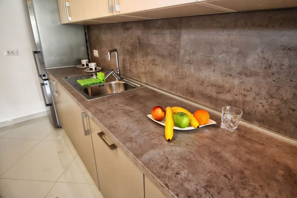 Deluxe Apartment | Private kitchen | Fridge