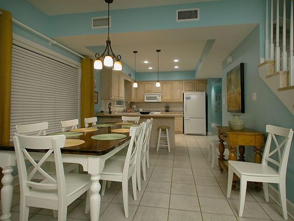 Dining room with table seating 10 + 4 additional persons at breakfast bar.