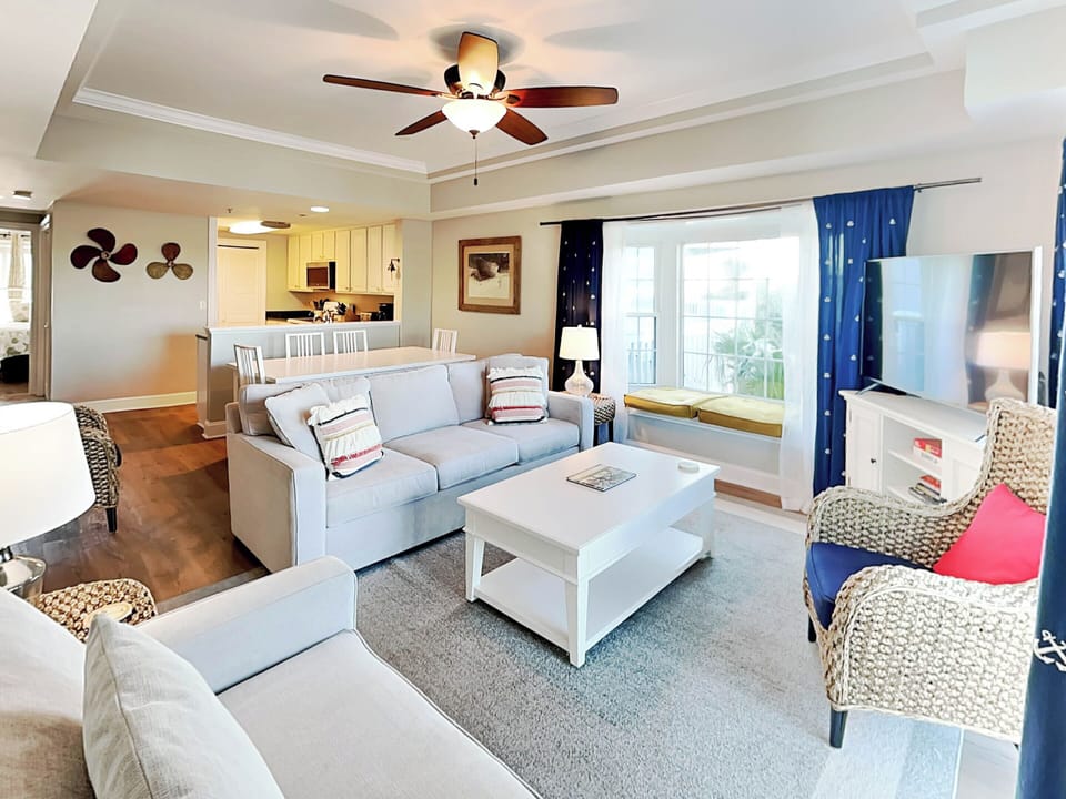 Open Living area with sleeper sofa, TV and views of the bay