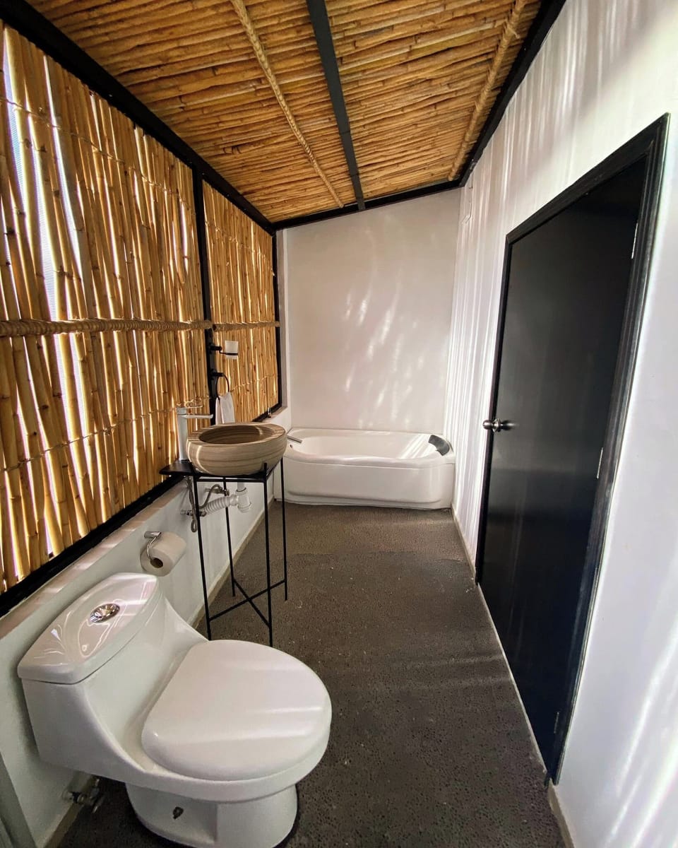 Deluxe Room, 1 King Bed | Bathroom | Shower, rainfall showerhead, hair dryer, towels