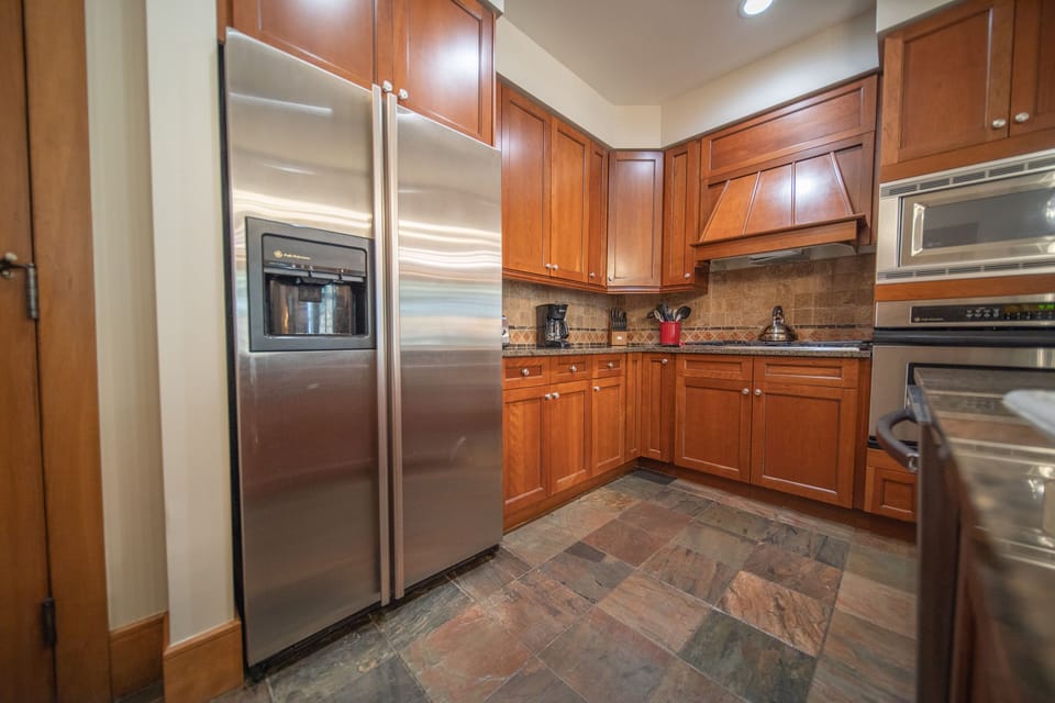 Fully equipped kitchen with cherry cabinets