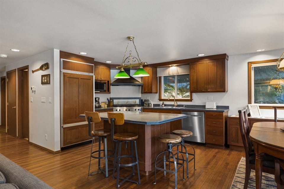 We see the MCM-inspired kitchen and the doorway to the downstairs bathroom on the left side of this image