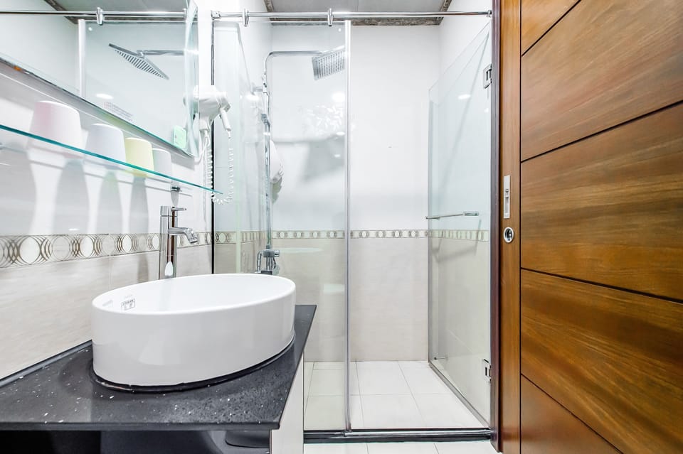 Quadruple Room, Lake View | Bathroom | Shower, hair dryer, slippers, towels