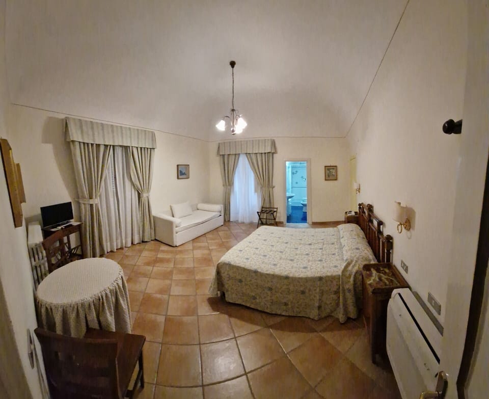 Deluxe Triple Room | In-room safe, desk, laptop workspace, blackout drapes