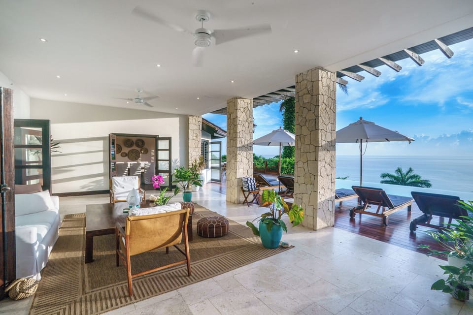 The veranda offers outdoor living with a view of the pool and ocean