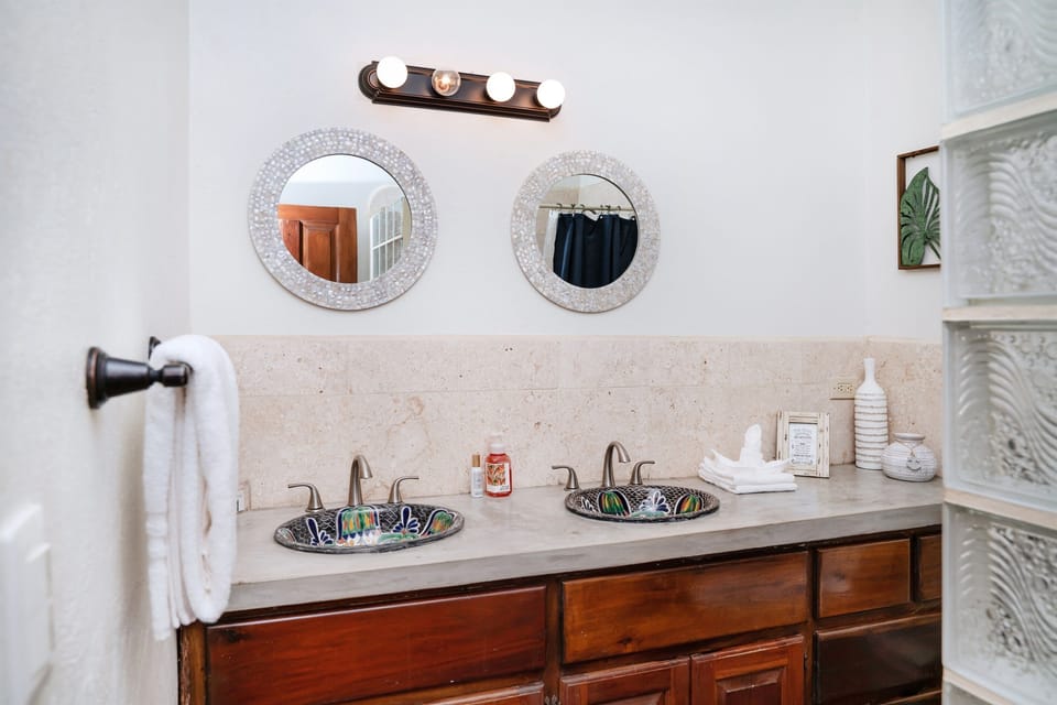 King bedroom ensuite bath with double sinks and walk in shower