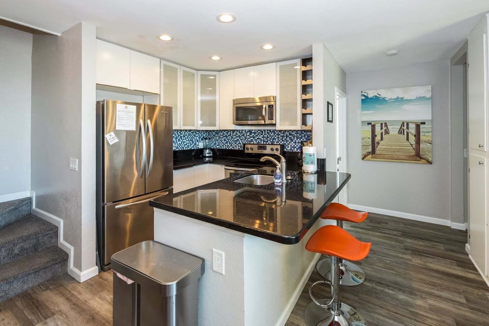 Fully stocked kitchen features all stainless steal appliances