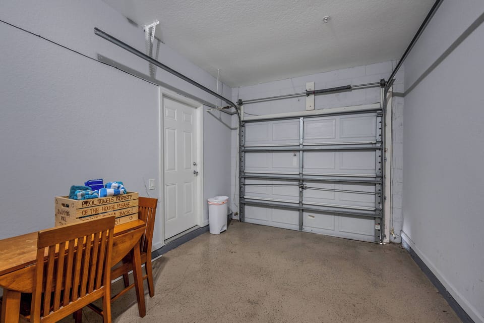 Laundry room located in garage with a full size washer and dryer