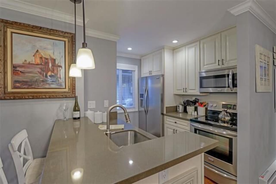 A spacious kitchen with all the essentials, from pots and pans to dishware and utensils, making meal prep a breeze