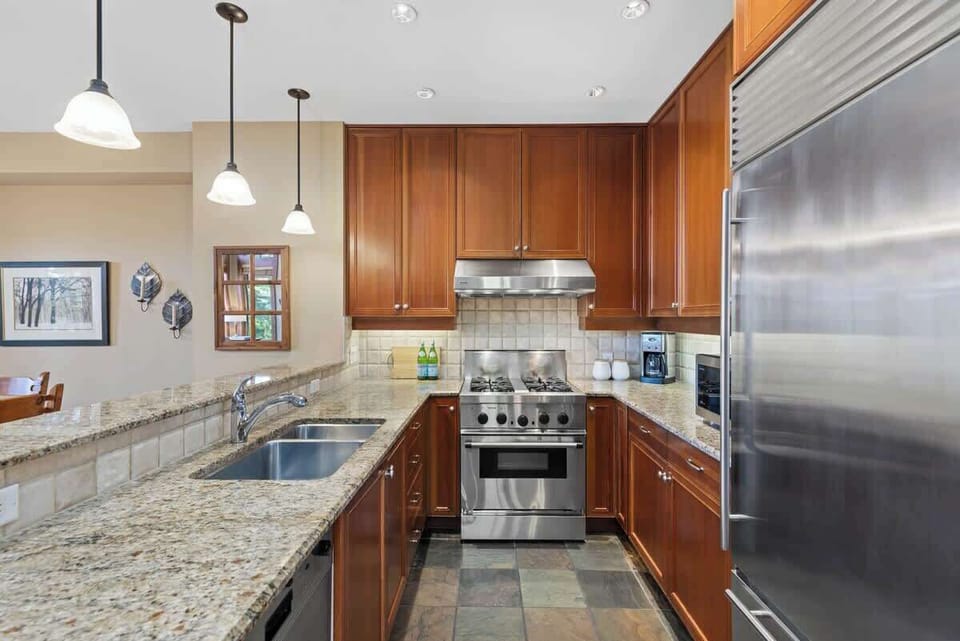 - Modern kitchen with stainless steel appliances and granite countertops  
- Fully equipped for cooking hearty meals after outdoor adventures  
- Elegant cabinetry and bright lighting enhance functionality  