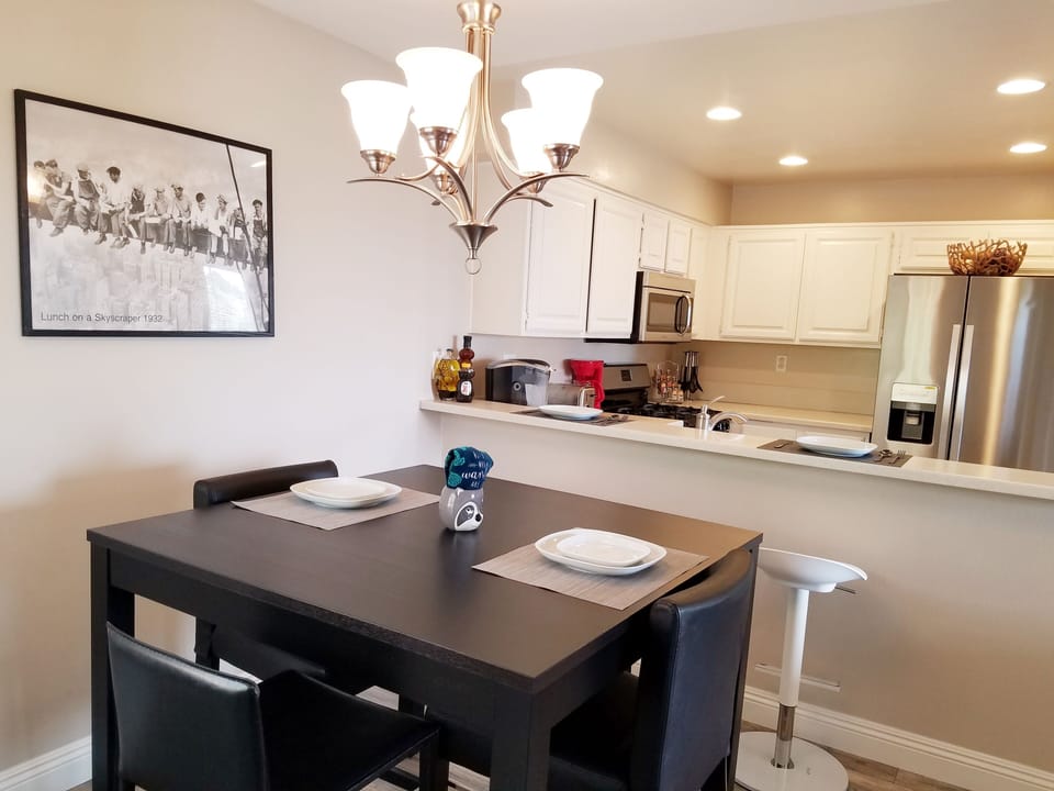 Dining room seats 4 and is adjacent from the breakfast bar.