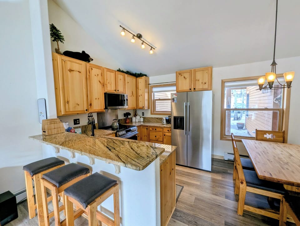 Cook memorable meals in your well-equipped kitchen featuring granite counters, stainless appliances, and a breakfast bar perfect for morning coffee.